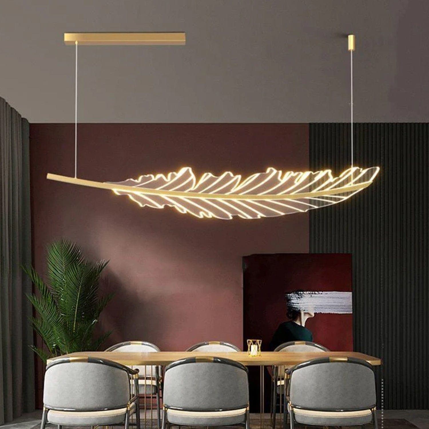 A restaurant dining table lit by a feather-form statement pendant