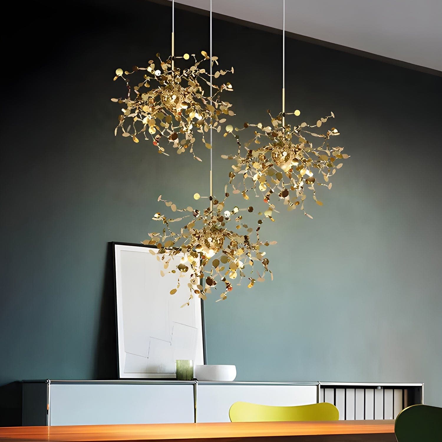 A bespoke astral debris chandelier suspended in a stairwell