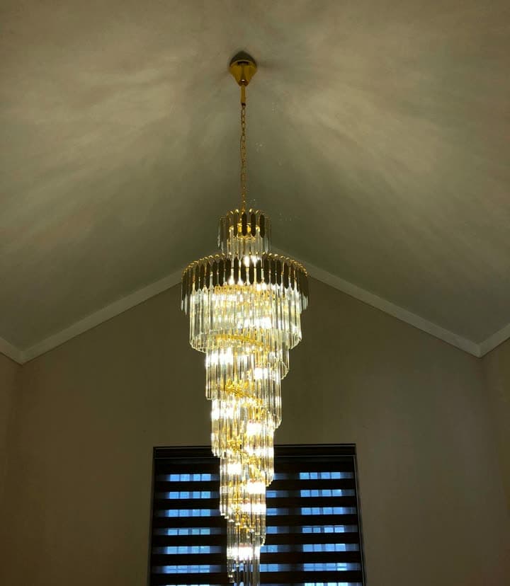 A tiered gold crystal cascade hanging the full height of a stairwell