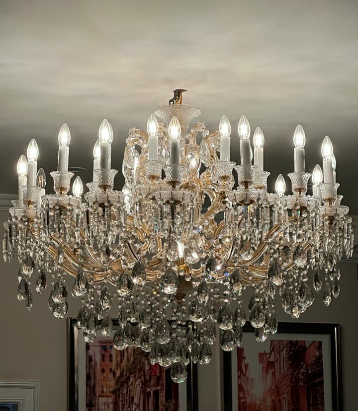 An ornate crystal candle chandelier lighting a living room